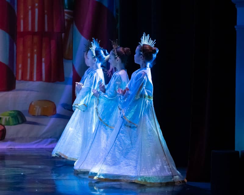 Sofia and Lauren kneeling arms in fifth